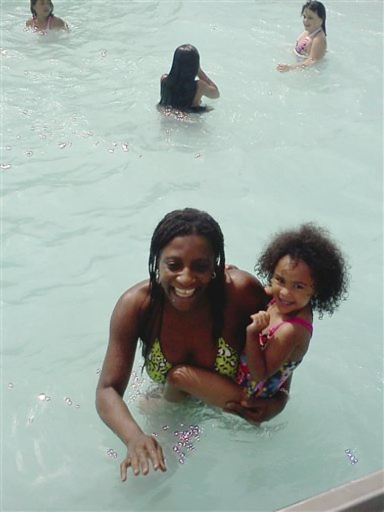 Marie Joseph, foreground, holding family friend Dalianys Melendez, the daughter of Candella Matta, in the public swimming pool at Lafayette Park in Fall River, Mass., on June 26. The body of Marie Joseph, 36, was found floating in the pool late Tuesday. She was last seen at the pool Sunday and had not been seen since. Officials are investigating whether her body was in the pool for more than two days while other people continued to swim. 